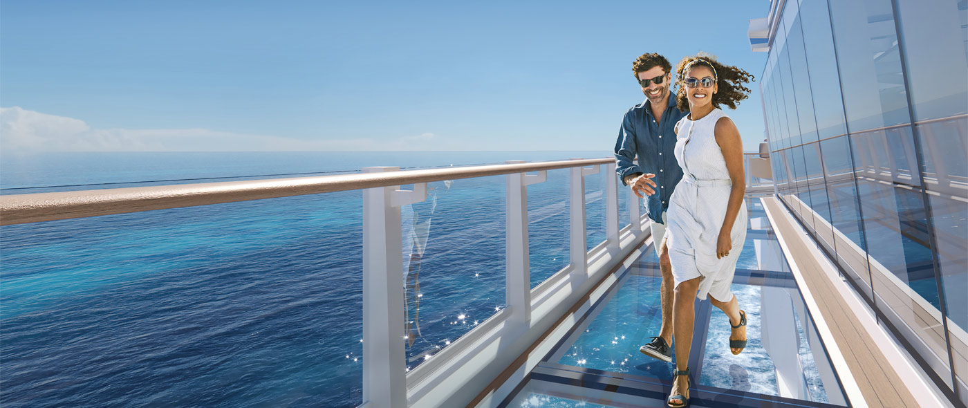 Couple running along Norwegian Luna's ocean promenade.