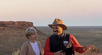 AAT-Kings image of two people having a discussion in a desert environment in Australia